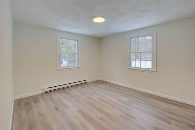 247 Quaker Ln, Scituate, RI 02857 - empty room with baseboard heating, wood finished floors, and baseboards