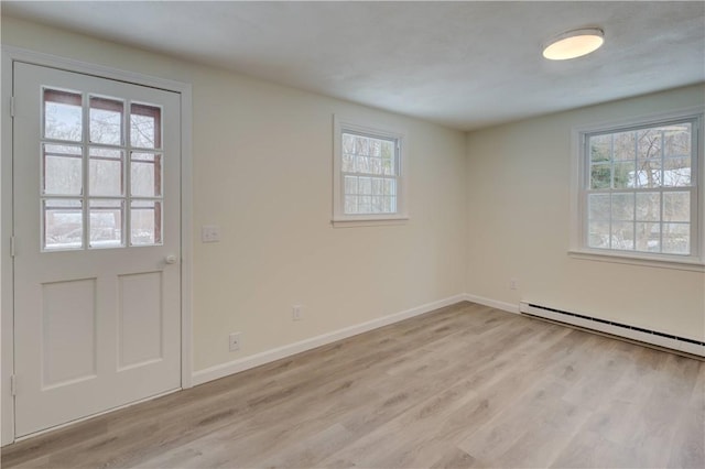 247 Quaker Ln, Scituate, RI 02857 - foyer entrance featuring healthy amount of natural light, a baseboard radiator, light wood-style flooring, and baseboards