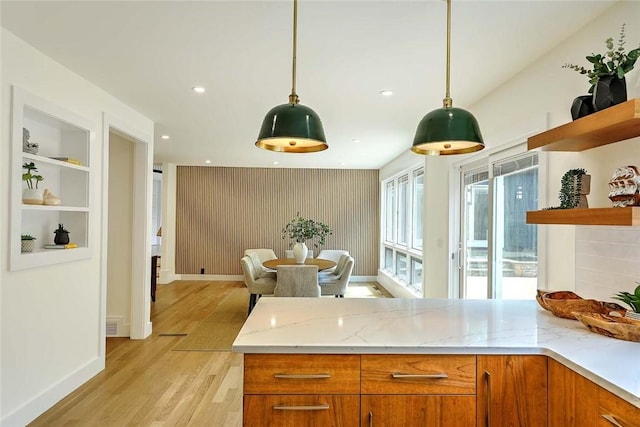kitchen featuring open shelves, light wood finished floors, baseboards, light stone countertops, and recessed lighting