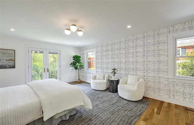 bedroom featuring access to outside, french doors, wood finished floors, recessed lighting, and baseboards