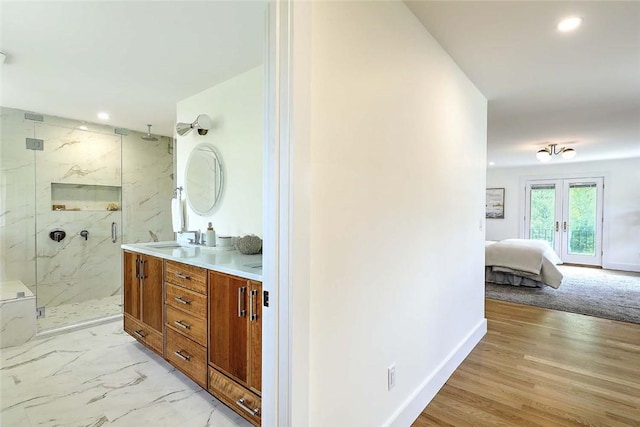 bathroom with french doors, a marble finish shower, recessed lighting, double vanity, and ensuite bathroom