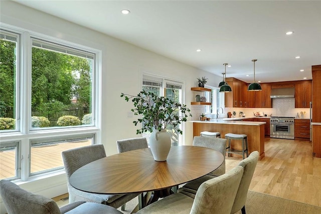 dining space with healthy amount of natural light, light wood finished floors, and recessed lighting