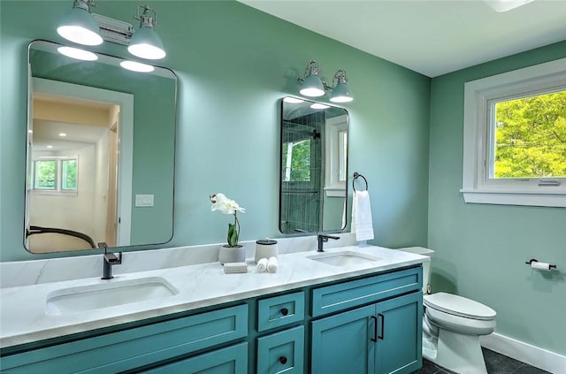 bathroom featuring toilet, double vanity, and tile patterned flooring