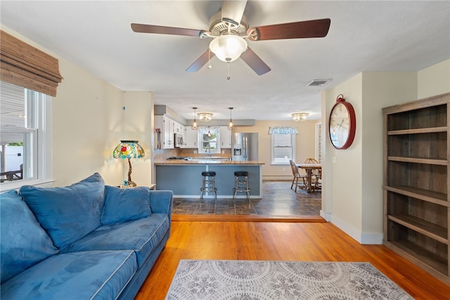 211 Iroquois Rd, Cumberland, RI 02864 - living area with wood finished floors, a ceiling fan, and baseboards
