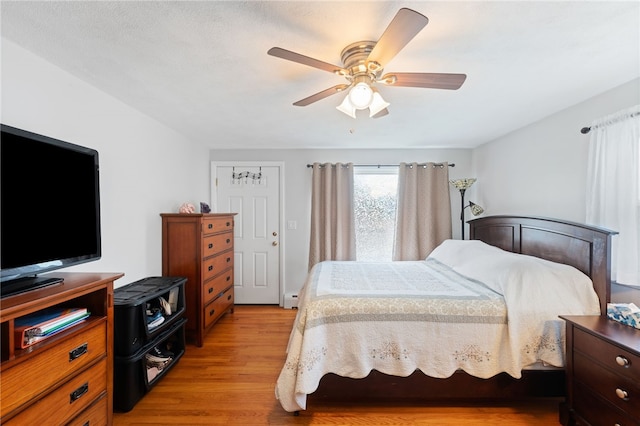 211 Iroquois Rd, Cumberland, RI 02864 - bedroom with light wood finished floors, a baseboard radiator, and a ceiling fan