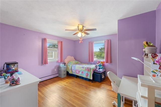 211 Iroquois Rd, Cumberland, RI 02864 - bedroom with a baseboard heating unit, light wood finished floors, and a ceiling fan