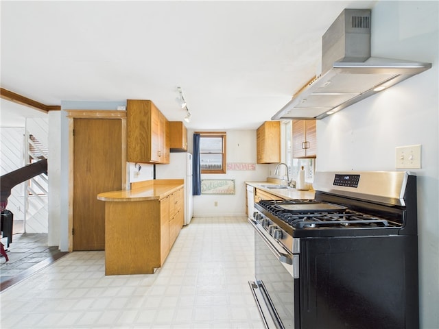kitchen featuring white appliances, wall chimney range hood, light floors, and light countertops