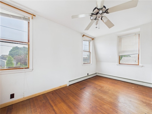 unfurnished room with hardwood / wood-style floors, plenty of natural light, and a ceiling fan