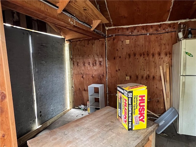 below grade area with freestanding refrigerator