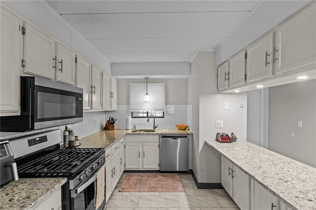 143 Hoffman Ave Unit 210, Cranston, RI 02920 - kitchen featuring stainless steel appliances, a sink, light stone counters, and light marble finish flooring
