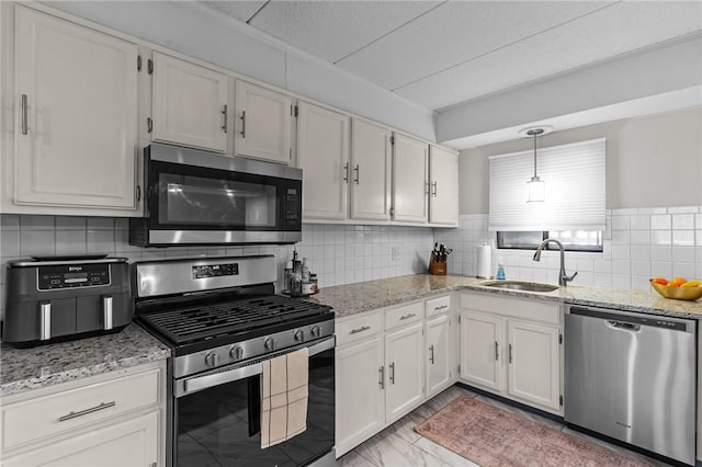 143 Hoffman Ave Unit 210, Cranston, RI 02920 - kitchen featuring stainless steel appliances, a sink, light stone countertops, and white cabinetry