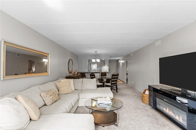 143 Hoffman Ave Unit 210, Cranston, RI 02920 - carpeted living area with a chandelier