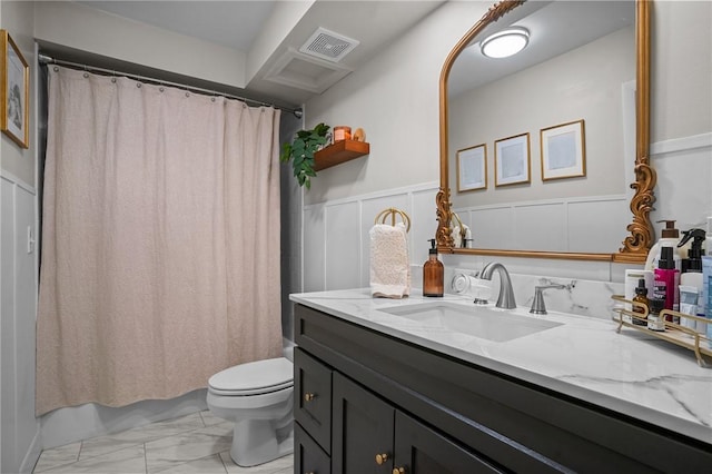 143 Hoffman Ave Unit 210, Cranston, RI 02920 - bathroom featuring marble look tile flooring, toilet, a decorative wall, a wainscoted wall, and vanity