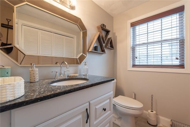 10 Flanders St, Johnston, RI 02919 - half bath with vanity, toilet, baseboards, and tile patterned floors