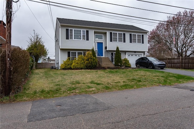 10 Flanders St, Johnston, RI 02919 - bi-level home with asphalt driveway, an attached garage, and central AC