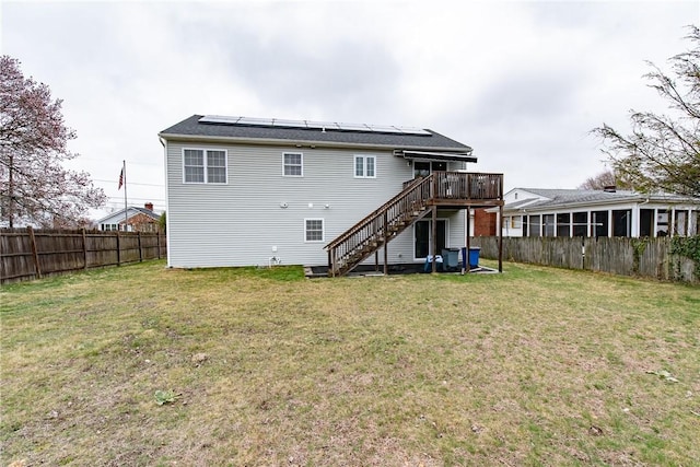 10 Flanders St, Johnston, RI 02919 - rear view of property with stairs, a deck, and roof mounted solar panels