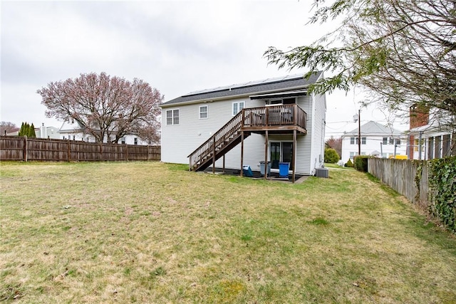 10 Flanders St, Johnston, RI 02919 - back of property featuring a deck, stairs, and central AC