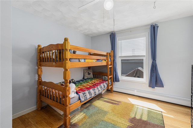 2 Sando St, Pawtucket, RI 02860 - bedroom featuring baseboard heating, wood finished floors, and baseboards