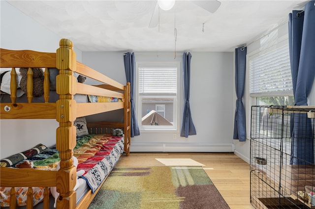 2 Sando St, Pawtucket, RI 02860 - bedroom with multiple windows, wood finished floors, baseboard heating, and baseboards