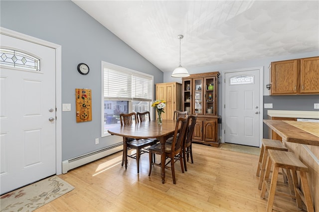 2 Sando St, Pawtucket, RI 02860 - dining space featuring a baseboard radiator, light wood-type flooring, and lofted ceiling