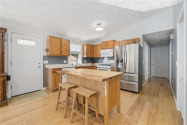 2 Sando St, Pawtucket, RI 02860 - kitchen with white appliances, butcher block countertops, light wood finished floors, vaulted ceiling, and a kitchen breakfast bar