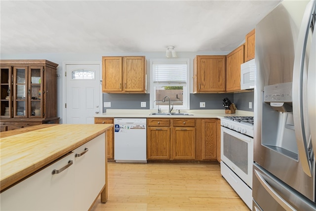2 Sando St, Pawtucket, RI 02860 - kitchen with white appliances, a sink, healthy amount of natural light, and light wood finished floors