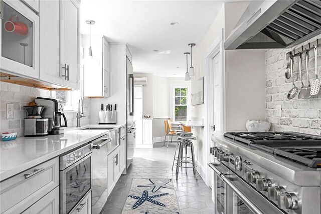 286 Kingstown Rd, Narragansett, RI 02882 - kitchen featuring appliances with stainless steel finishes, under cabinet range hood, backsplash, light countertops, and a sink