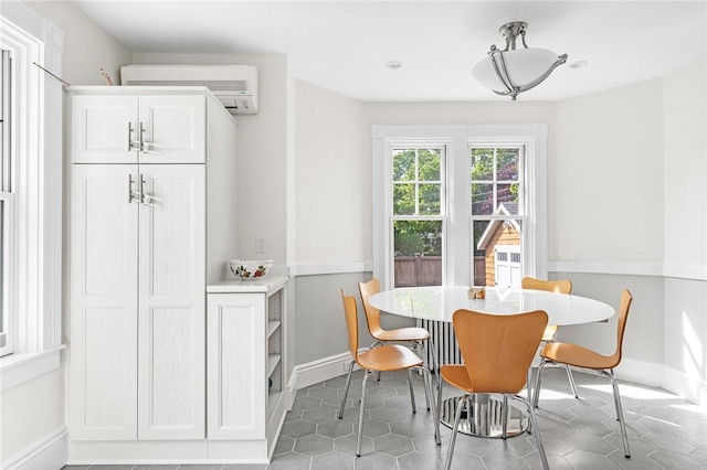 286 Kingstown Rd, Narragansett, RI 02882 - tiled dining room with an AC wall unit and baseboards