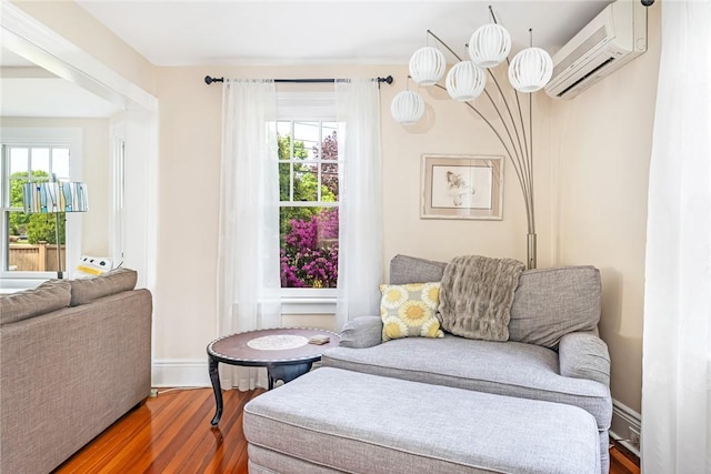 286 Kingstown Rd, Narragansett, RI 02882 - living area featuring wood finished floors, a wall mounted AC, and baseboards