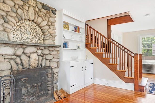 286 Kingstown Rd, Narragansett, RI 02882 - stairs with wood finished floors, radiator, baseboards, and a fireplace