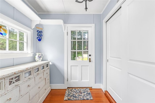 286 Kingstown Rd, Narragansett, RI 02882 - entryway featuring light wood finished floors, baseboards, and ornamental molding