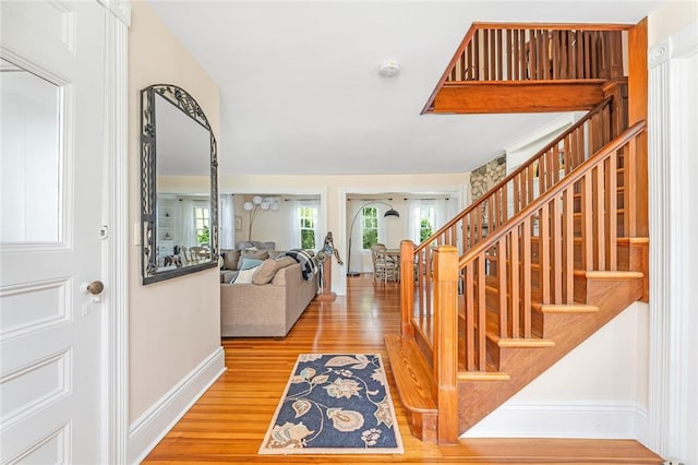286 Kingstown Rd, Narragansett, RI 02882 - entrance foyer with baseboards, wood finished floors, and stairs