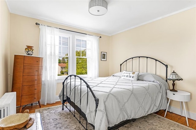 286 Kingstown Rd, Narragansett, RI 02882 - bedroom with wood finished floors, radiator, baseboards, and crown molding