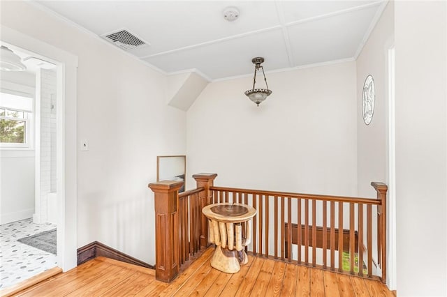 286 Kingstown Rd, Narragansett, RI 02882 - hall with light wood-style flooring, an upstairs landing, ornamental molding, and baseboards