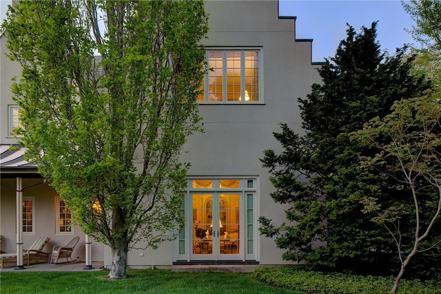 14 Leroy Ave, Newport, RI 02840 - rear view of property featuring stucco siding, a patio area, and a lawn