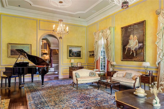 14 Leroy Ave, Newport, RI 02840 - living area with arched walkways, wood finished floors, a chandelier, a decorative wall, and crown molding
