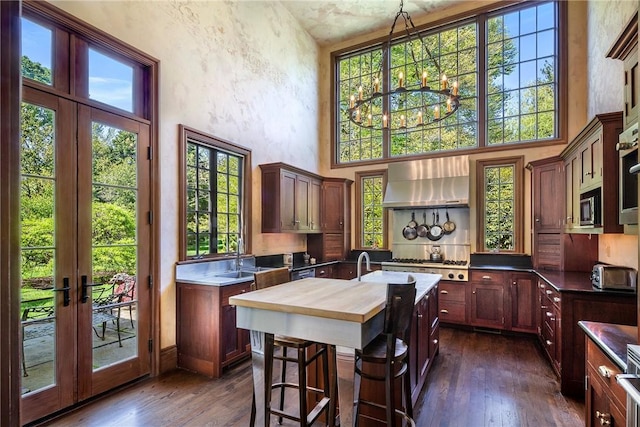 14 Leroy Ave, Newport, RI 02840 - kitchen with extractor fan, butcher block countertops, a towering ceiling, dark wood-style flooring, and french doors