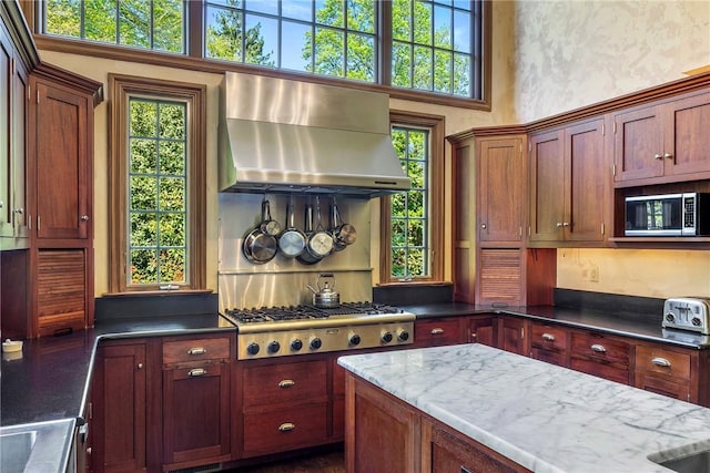 14 Leroy Ave, Newport, RI 02840 - kitchen featuring extractor fan, stainless steel appliances, a towering ceiling, and dark stone countertops