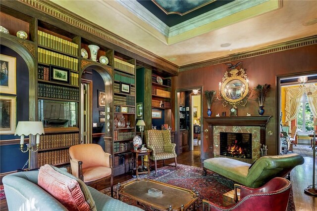 14 Leroy Ave, Newport, RI 02840 - living area with wood finished floors, arched walkways, a premium fireplace, crown molding, and built in features