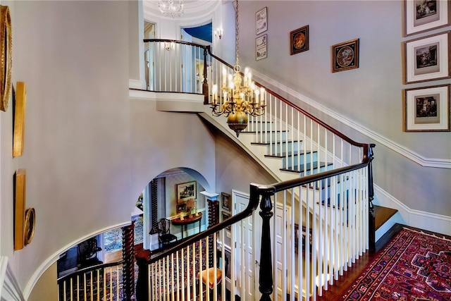 14 Leroy Ave, Newport, RI 02840 - staircase featuring a chandelier, arched walkways, and a high ceiling