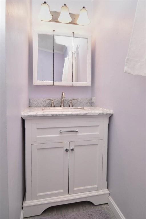 bathroom featuring vanity and baseboards