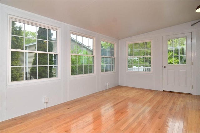 unfurnished sunroom with lofted ceiling