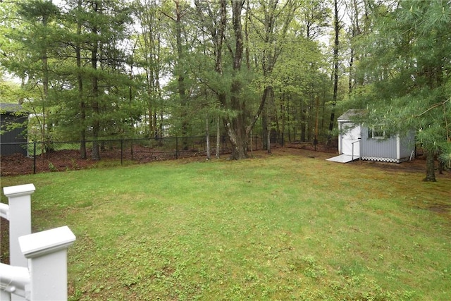 view of yard with a storage shed and an outbuilding