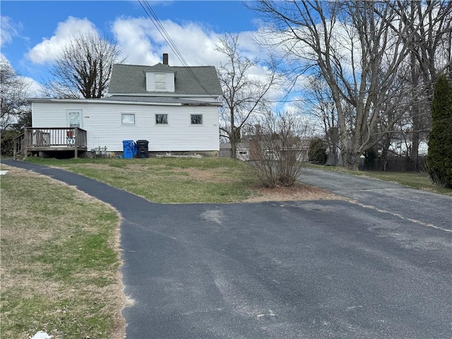 226 Marshall Ave, Cumberland, RI 02864 - view of property exterior with a deck, a chimney, a lawn, driveway, and a shingled roof