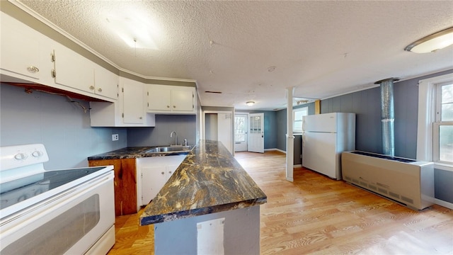226 Marshall Ave, Cumberland, RI 02864 - kitchen featuring white appliances, a sink, dark countertops, a textured ceiling, and white cabinets