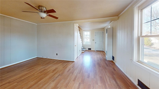 226 Marshall Ave, Cumberland, RI 02864 - empty room with light wood-style floors, a ceiling fan, crown molding, wooden walls, and a textured ceiling