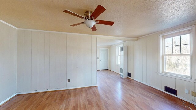 226 Marshall Ave, Cumberland, RI 02864 - spare room with wood finished floors, baseboards, ceiling fan, a textured ceiling, and wood walls