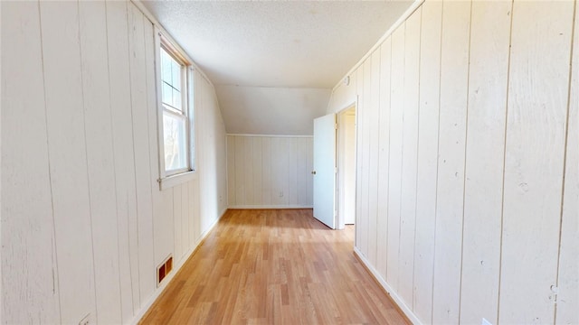 226 Marshall Ave, Cumberland, RI 02864 - bonus room featuring light wood-style flooring, wood walls, a textured ceiling, and baseboards