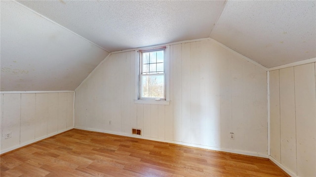 226 Marshall Ave, Cumberland, RI 02864 - additional living space with wood finished floors, lofted ceiling, and a textured ceiling
