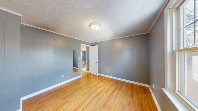 226 Marshall Ave, Cumberland, RI 02864 - spare room with wood finished floors, ornamental molding, plenty of natural light, a textured ceiling, and baseboards